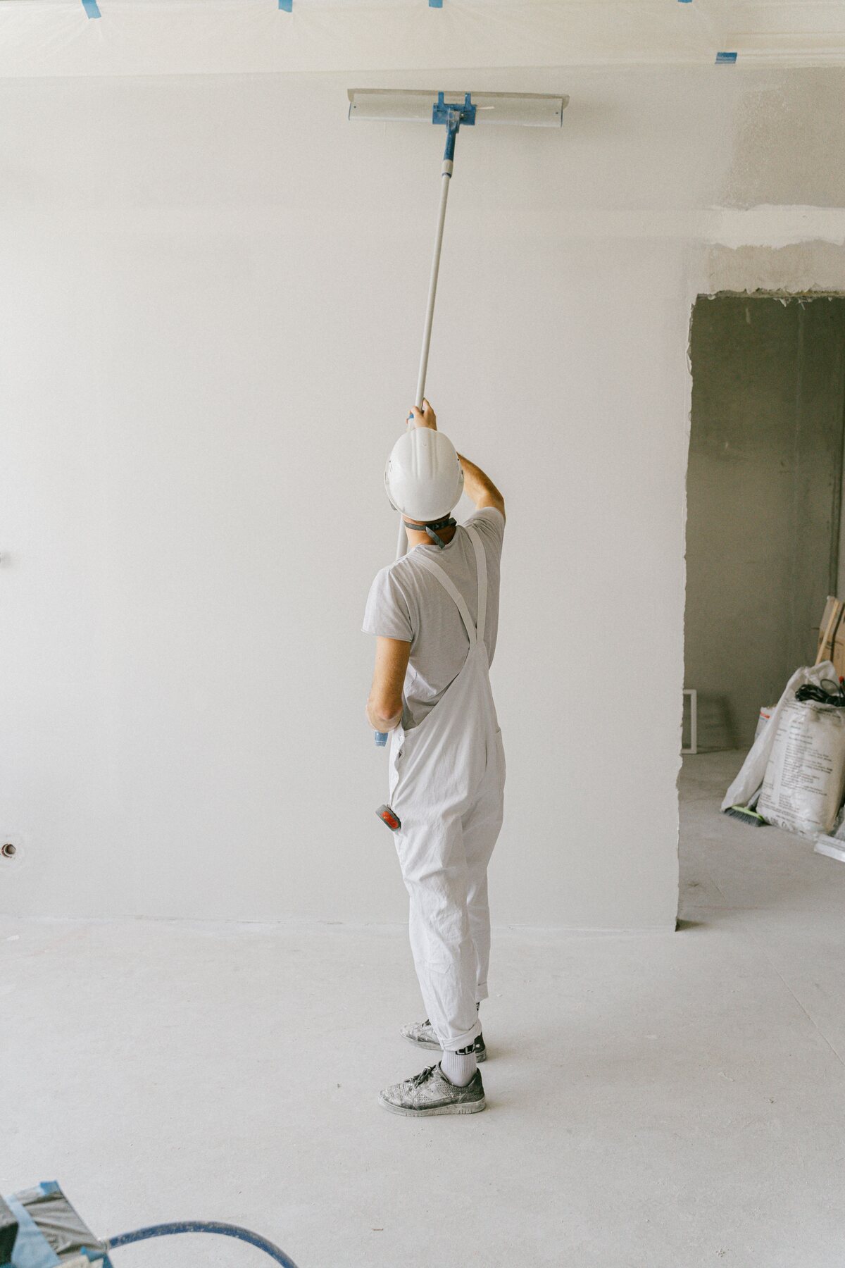 Professional painter applying a clean finish to an interior wall