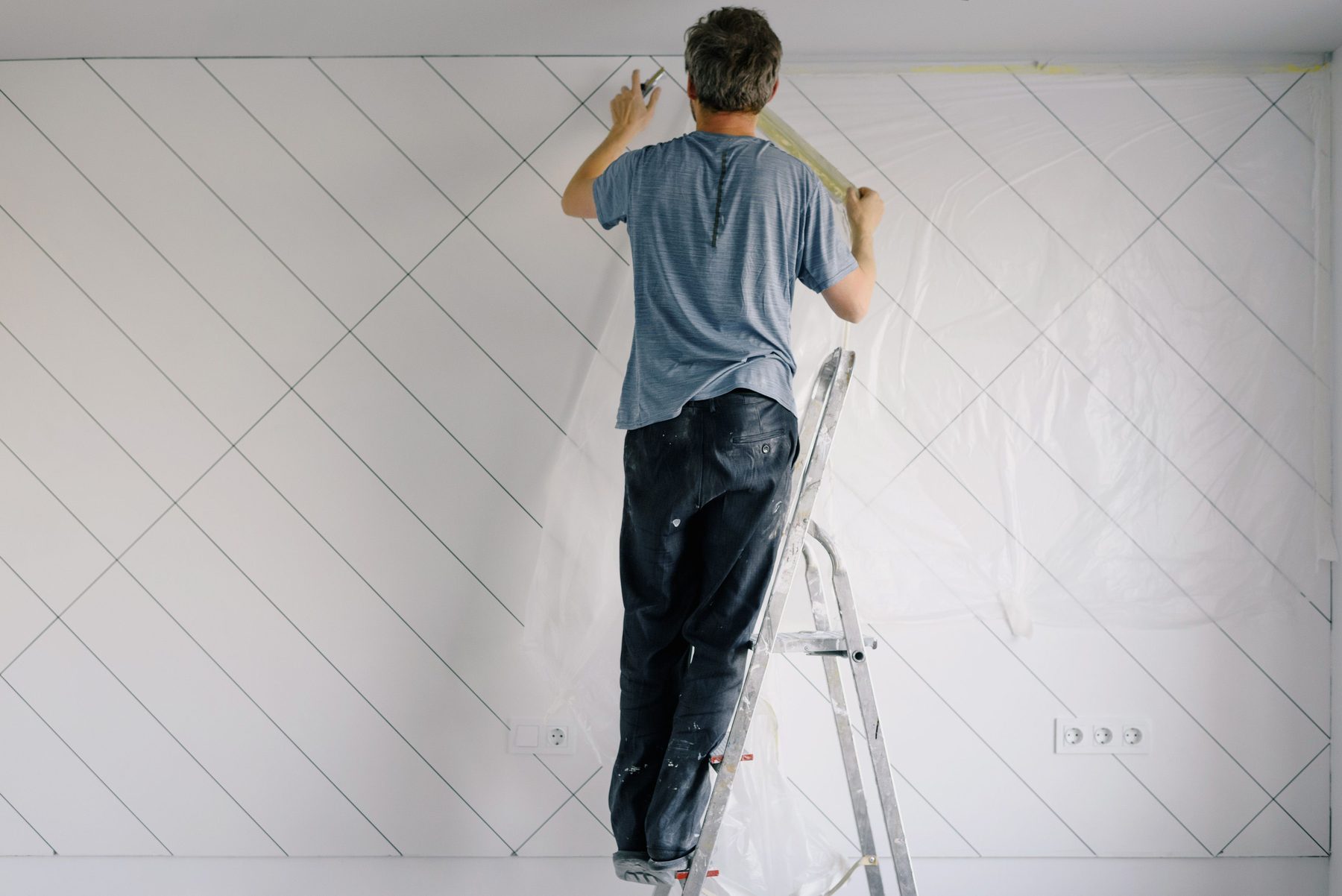 Painter preparing a wall for a clean finish